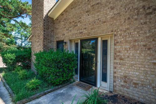 a brick house with a sliding glass door at Woodland Springs in Gladewater
