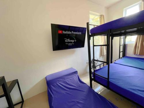 a bedroom with two bunk beds and a sign on the wall at Big Group 2BR in Dasmariñas Aguinaldo Highway Subdivision in Dasmariñas