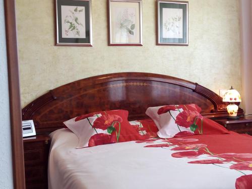 a bedroom with a large bed with red and white pillows at Luxury Flat in Málaga