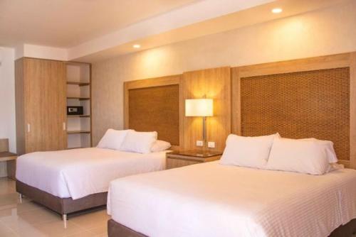 Postel nebo postele na pokoji v ubytování Hotel Campestre las Camelias