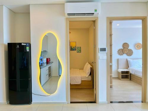 a room with a refrigerator and a bedroom with a bed at The Song Premium Apartment - Căn Hộ Du Lịch Biển - Anh Khoa Homestay in Vung Tau
