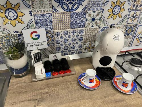 a counter with cups and plates on a table at Donn'Anna Naples City Center in Naples