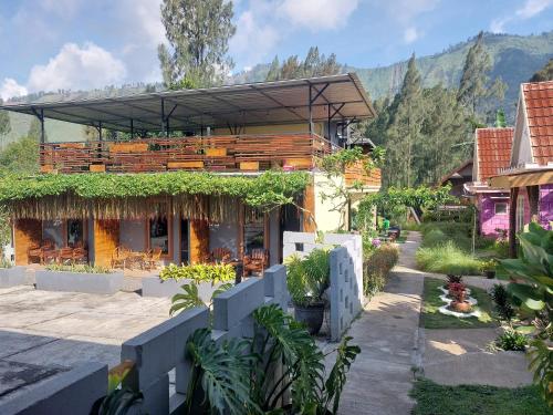a house with a balcony with plants on it at Istana Bromo Resort in Bromo
