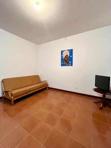 a room with a bed and a tv in it at Casa BB&Djassi - Apartment T1 in Ponta do Sol