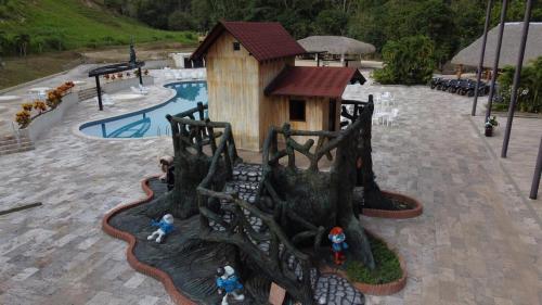 a model of a tree house in the middle of a pool at hacienda hotel texas in Durania