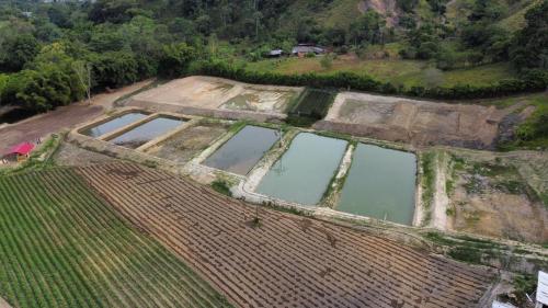 an aerial view of a field with a body of water at hacienda hotel texas in Durania
