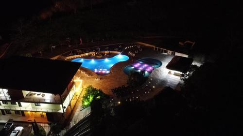 an overhead view of a swimming pool at night at hacienda hotel texas in Durania
