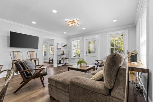 a living room with a couch and a tv at 4BR Bright and Modern - Close to Everything in Charlotte