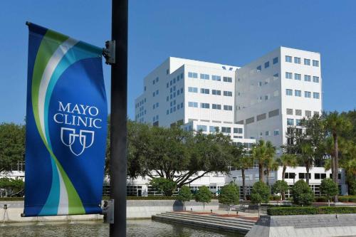 a large building with a sign in front of it at Nice 2 BR Apt|King Bed|Pool |Gym|Clse 2 Beach/Mayo in Sandalwood