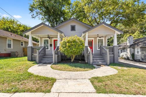 a house with a tree in the front yard at 4BR Bright and Modern - Close to Everything in Charlotte