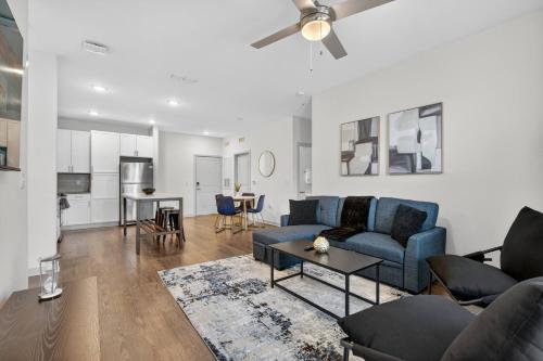 a living room with a blue couch and a table at Nice 2 BR Apt|King Bed|Pool |Gym|Clse 2 Beach/Mayo in Sandalwood