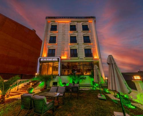 a building with a table and chairs and an umbrella at The Private Airport Hotel in Istanbul