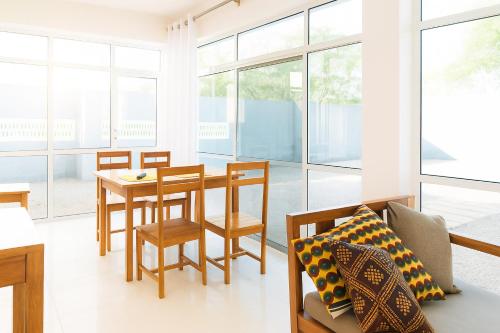 a living room with a table and chairs at Beachfront Bliss Zanzibar - Stylish 1BR Oceanview Apartment in Uroa in Uroa