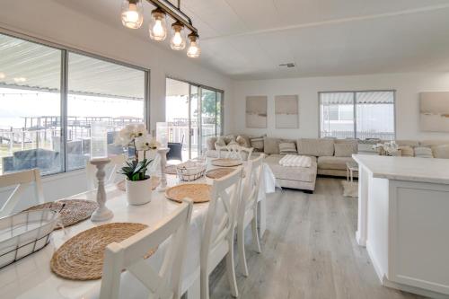 a kitchen and living room with a table and chairs at Hot Tub, Views and Dock! Playful Home on Clear Lake in Nice