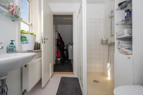 a small bathroom with a sink and a toilet at Ilulissat Stay - Nanna's Villa - 1 in Ilulissat