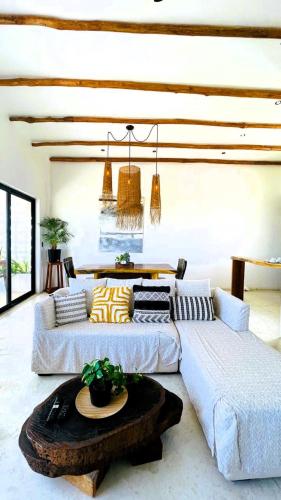 a living room with two couches and a table at Ikal Island Garden in Isla Mujeres