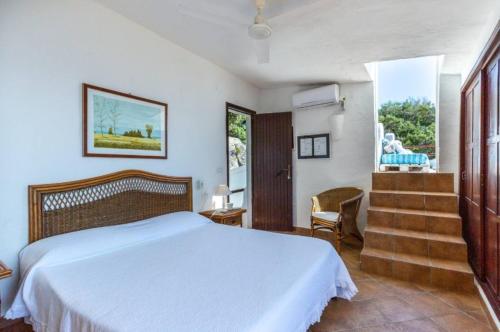 a bedroom with a white bed and a window at Villa Renata Torre delle Stelle in Torre delle Stelle