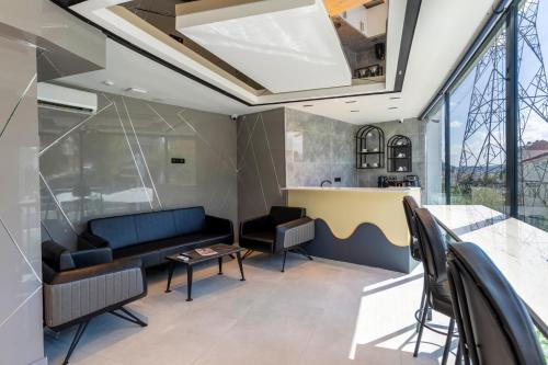 a living room with a couch and a table at The Private Airport Hotel in Istanbul