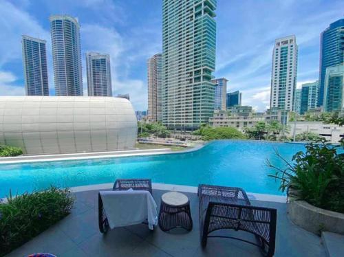 a swimming pool with a view of a city skyline at Novotel Hotel Residences Manila by AMORE Suites in Manila