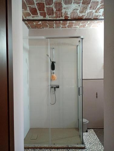 a bathroom with a shower with a glass door at Il Murôn Guest House in Carentino