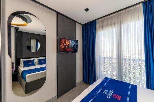 a hotel room with a bed and a mirror at The Private Airport Hotel in Istanbul