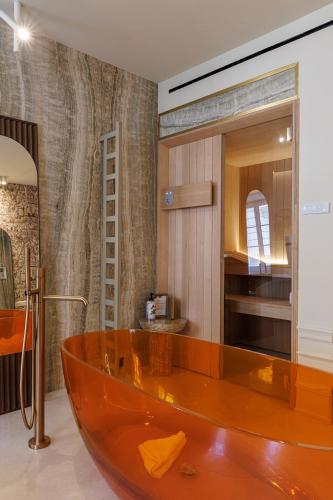 a bathroom with a wooden tub in a room at Le Dortoir Boutique Suites in Nice