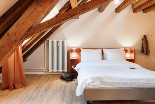 a bedroom with a large bed in a attic at Stay Sunday in Zürich