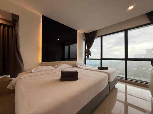 a bedroom with a large bed with a large window at QUINCE HOME GRAND ION DELEMEN GENTING HIGHLANDs in Genting Highlands