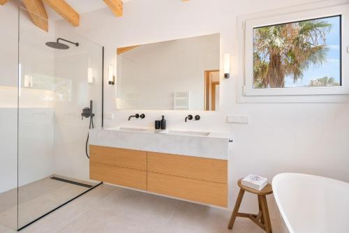 a bathroom with a sink and a mirror at Melodie home Menorca in Sa Caleta
