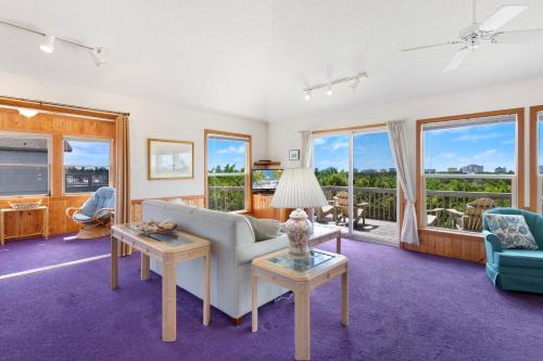 a living room with a couch and a table at 8455 - Mad Hatteras in Avon
