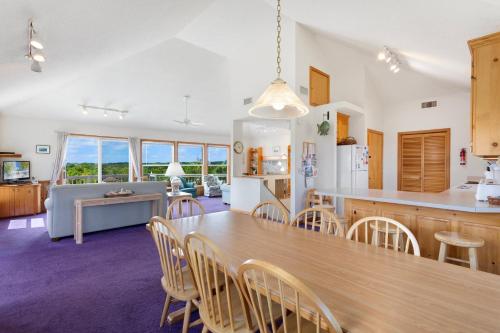 a kitchen and dining room with a table and chairs at 8455 - Mad Hatteras in Avon