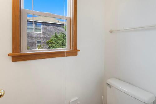 a bathroom with a toilet and a window at 8455 - Mad Hatteras in Avon