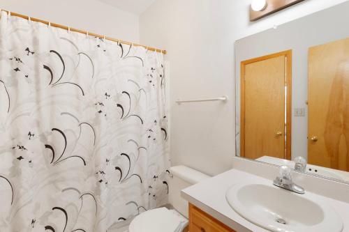 a bathroom with a toilet and a shower curtain at 8455 - Mad Hatteras in Avon
