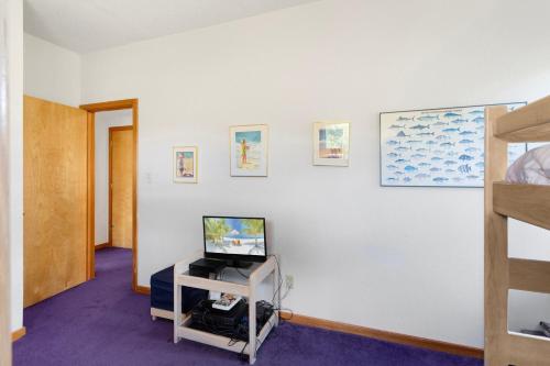 a room with a tv and a white wall at 8455 - Mad Hatteras in Avon