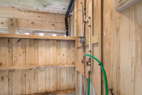 a wood paneled room with a green hose at 8455 - Mad Hatteras in Avon