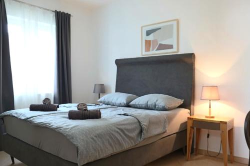 a bedroom with a large bed with blue pillows at BOŽICA House with apartments in Murine