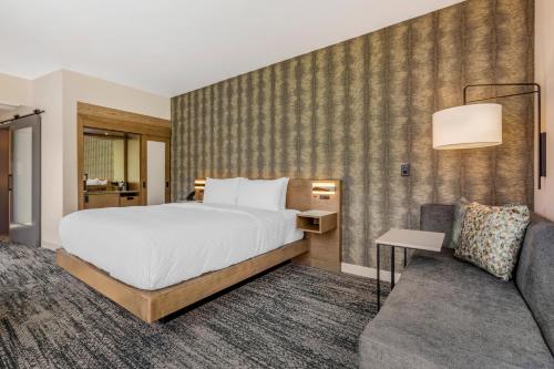 a hotel room with a bed and a couch at Cambria Hotel Portland - Pearl District in Portland