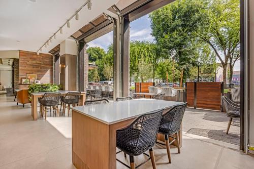 an outdoor patio with tables and chairs and a bar at Cambria Hotel Portland - Pearl District in Portland