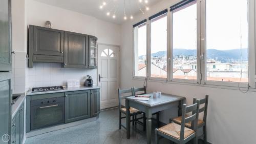 a kitchen with a table and a small table and chairs at Italianway - Roma 70 in Sanremo