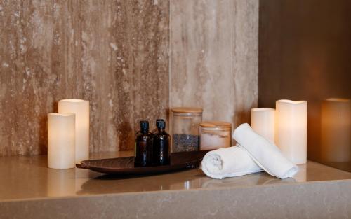 a tray with wine bottles and candles on a counter at Hotel Sinaia in Sinaia