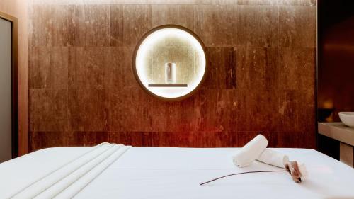 a bedroom with a bed with a mirror on the wall at Hotel Sinaia in Sinaia