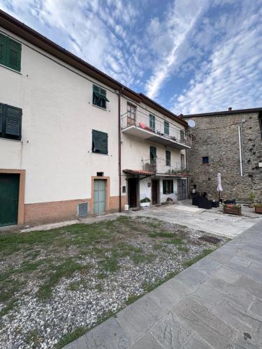 a large white building with a yard in front of it at L'Autedo in Riccò del Golfo di Spezia