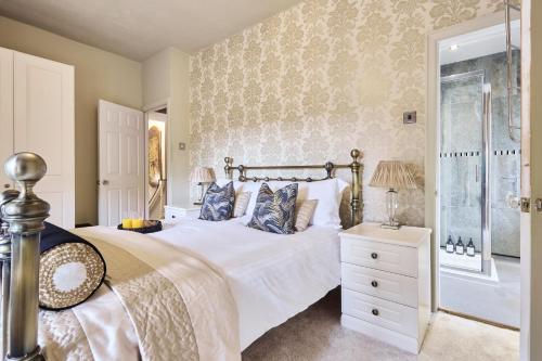 a bedroom with a large bed and a shower at Above Rubies - Cross Cottage, Luxury, Dog Friendly in Haworth