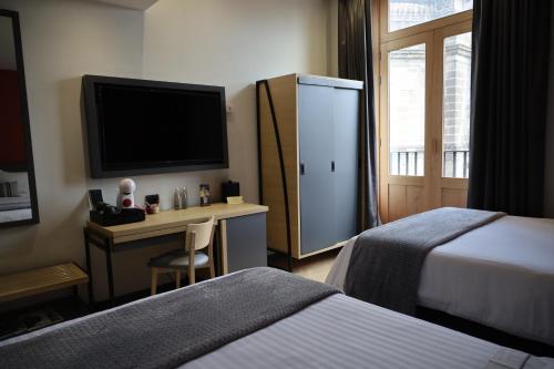 Кровать или кровати в номере Hotel Catedral