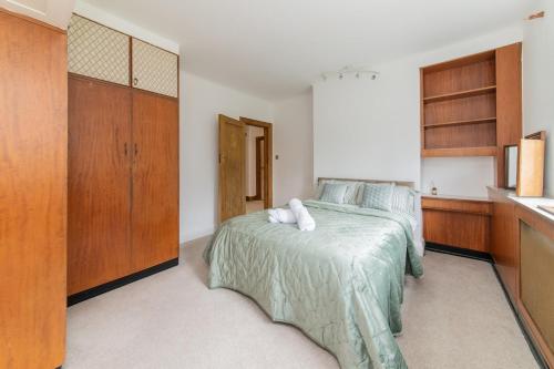 a bedroom with a bed and a kitchen at Elegant Tudor Venue in Stone Grove