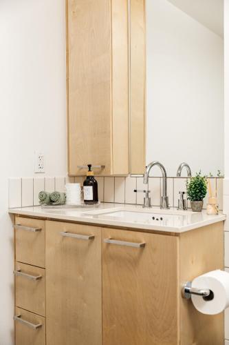 a kitchen with wooden cabinets and a sink at Superior 2 bedroom apartment in Heart of Hollywood in Los Angeles