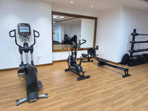 a gym with treadmills and ellipticals and a mirror at Luxury 2-Bedroom APT - Sea Views in Saadiyat Island in Abu Dhabi