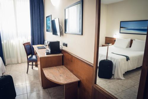 Postel nebo postele na pokoji v ubytování Rivoli Hotel
