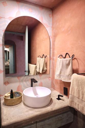 a bathroom with a white sink and a mirror at Casa Malagua Hotel Boutique in Puerto Escondido