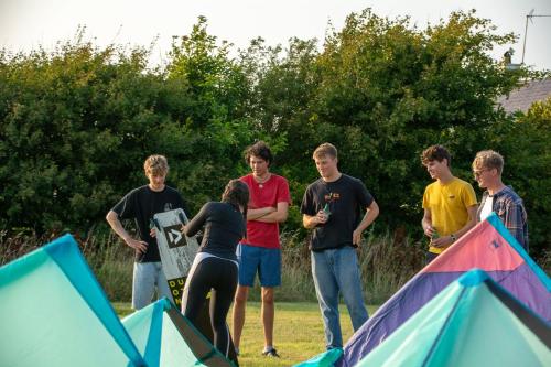a group of young people standing around a tent at The Old Dairy in Holyhead